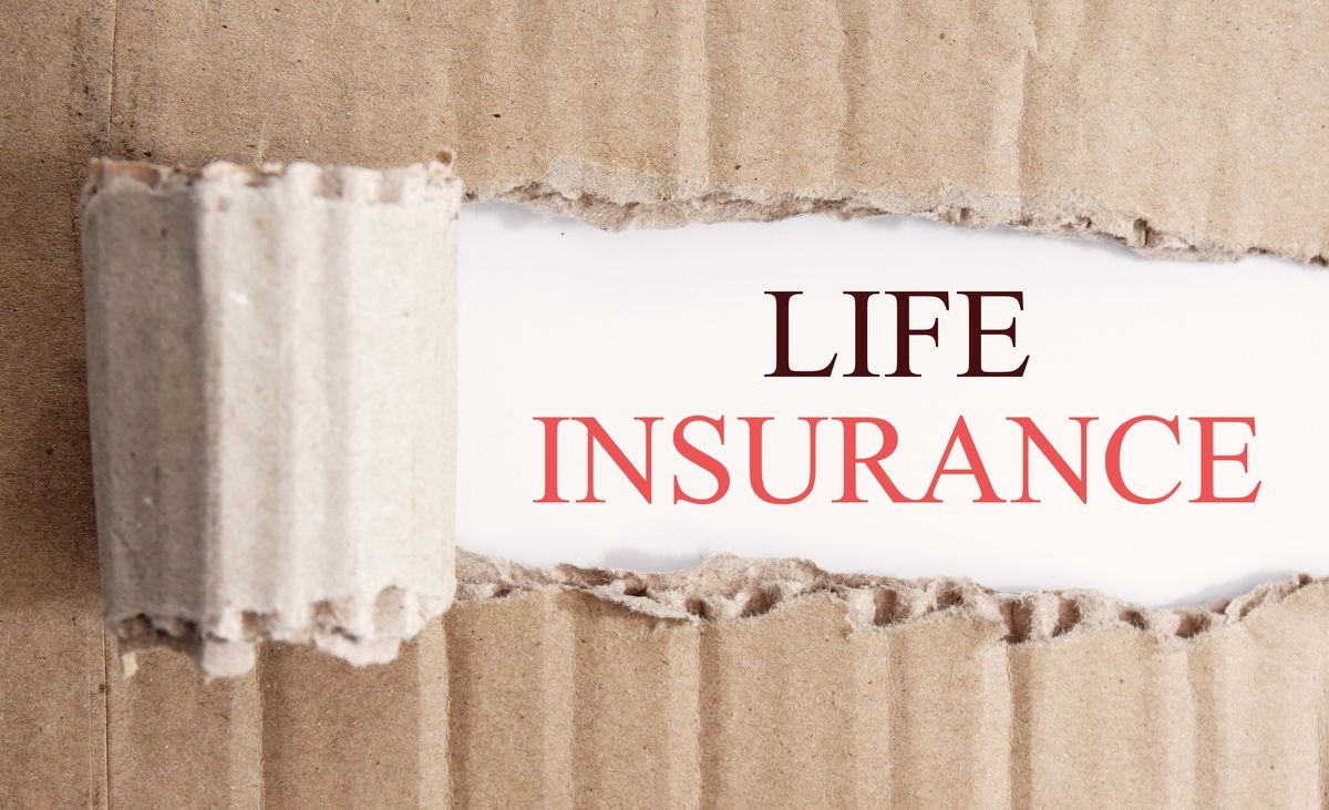 brown paper torn off revealing a white section. life insurance text written on white section